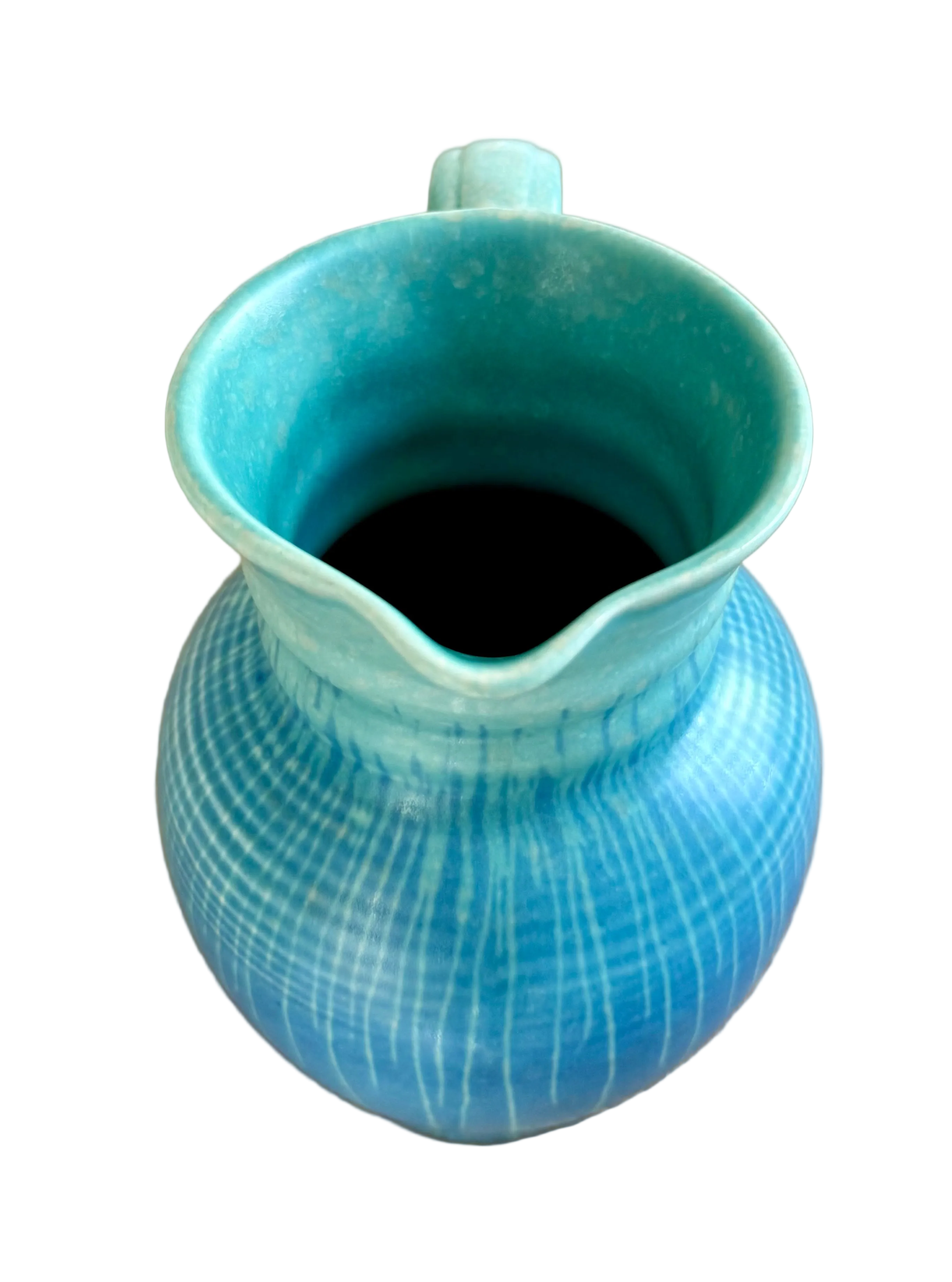 Blue ceramic pitcher on a wooden surface